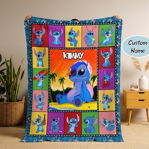 May include: A blue blanket featuring a colorful patchwork design with images of a cartoon character. The central panel displays the character with the name "KIMMY" above it. The blanket has a blue border with repeating character patterns.