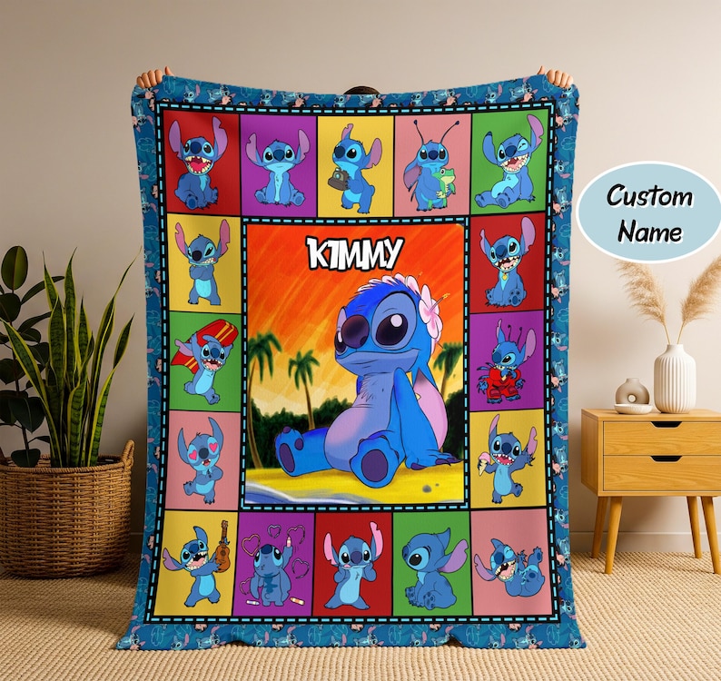 May include: A blue blanket featuring a colorful patchwork design with images of a cartoon character. The central panel displays the character with the name "KIMMY" above it. The blanket has a blue border with repeating character patterns.