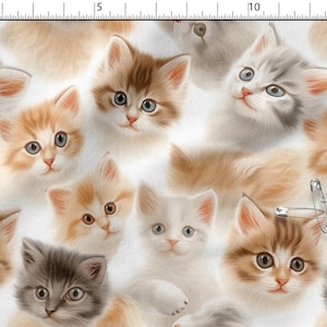 May include: A repeating pattern of kitten faces in shades of orange, brown, grey, and white. The kittens have blue or brown eyes and are set against a white background. A few safety pins are also visible.