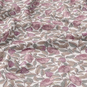 May include: A fabric with a floral pattern featuring pink peony-like flowers and green and brown leaves on a white background. The fabric is wrinkled, suggesting it is draped or folded. The design is a repeating pattern, suitable for various sewing projects.