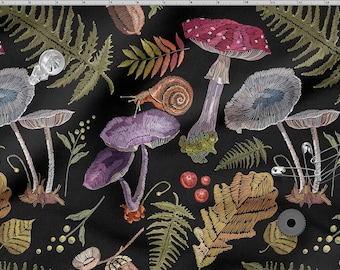 May include: Black fabric featuring embroidered mushrooms, ferns, leaves, and a snail. The mushrooms are purple, red, and blue. Ferns and leaves are green and brown. The design includes safety pins and a small gear.