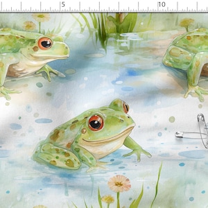 Peut inclure: Tissu aquarelle représentant plusieurs grenouilles vertes aux yeux rouges dans un étang. La scène comprend des plantes aquatiques, des fleurs et plusieurs épingles de sûreté argentées. Les grenouilles sont au centre.