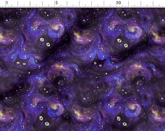 May include: Fabric with a repeating pattern of black cat faces and glowing yellow eyes against a swirling purple and blue galaxy background. The design includes white stars and nebulas.