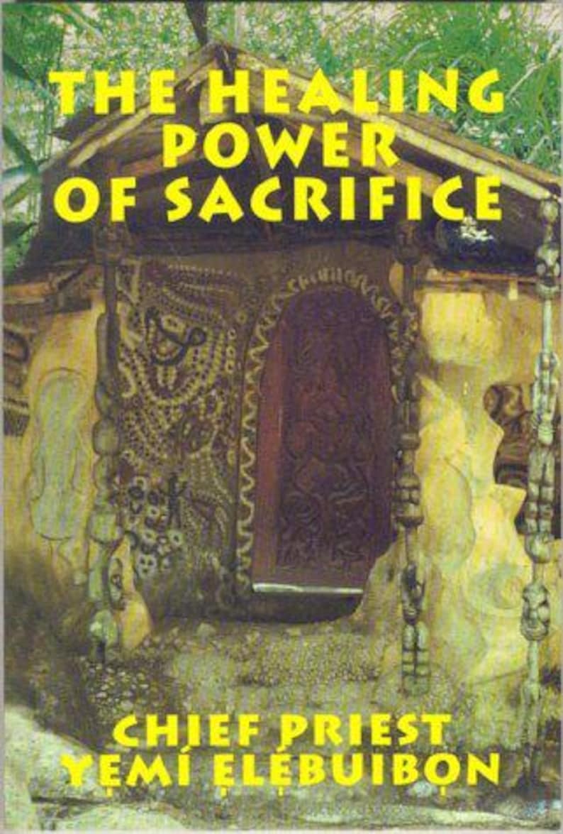 May include: A book cover with a yellow title "The Healing Power of Sacrifice" and the author's name "Chief Priest Yemi Elebuibon" in yellow text. The cover features a wooden doorway with intricate carvings and a dark wooden door.