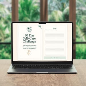 May include: A laptop displaying a digital self-care journal. The screen shows the title "30 Day Self-Care Challenge" with floral illustrations. The journal includes space for notes and prompts for daily well-being, set against a blurred green background.