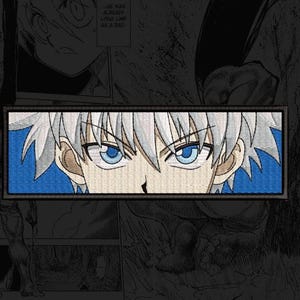May include: A rectangular embroidered patch featuring a close-up of an anime character with spiky white hair and intense blue eyes. The character has a focused expression, with sharp eyebrows and a blue background behind the head, framed by a black border.