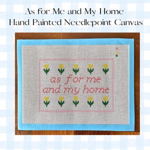 May include: Hand-painted needlepoint canvas with the text "As for Me and My Home." The canvas features a light blue border and a pink rectangular design with the words "as for me and my home" stitched in pink.