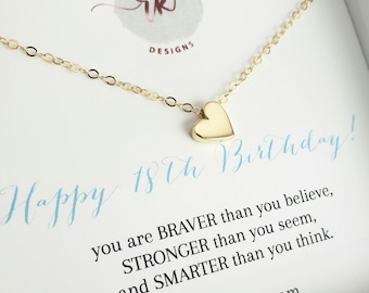 May include: A gold-colored heart pendant necklace. The necklace is on a white card with the text "Happy 18th Birthday!" and a motivational quote. The brand name "rk designs" is also visible.