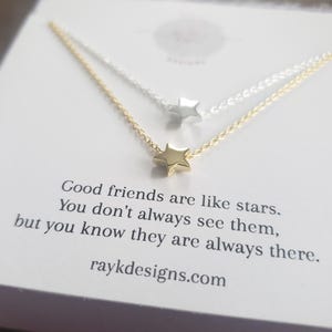 May include: Two delicate star necklaces, one gold and one silver, are displayed on a white card. The card features the text "Good friends are like stars. You don't always see them, but you know they are always there." and the website raykdesigns.com.