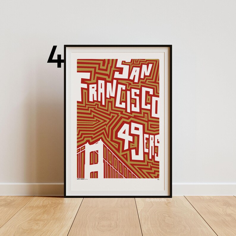 May include: Framed art print with the words "SAN FRANCISCO 49ERS" in white, set against a red and gold background. The Golden Gate Bridge is illustrated at the bottom. The print is in a black frame.