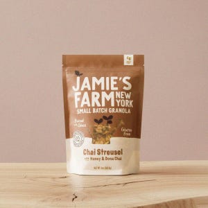 May include: A brown and white bag of Jamie's Farm New York Chai Streusel granola. The bag features the text "Small Batch Granola", "Baked with Ghee", and "Gluten Free". The net weight is 8 oz (226.8g).