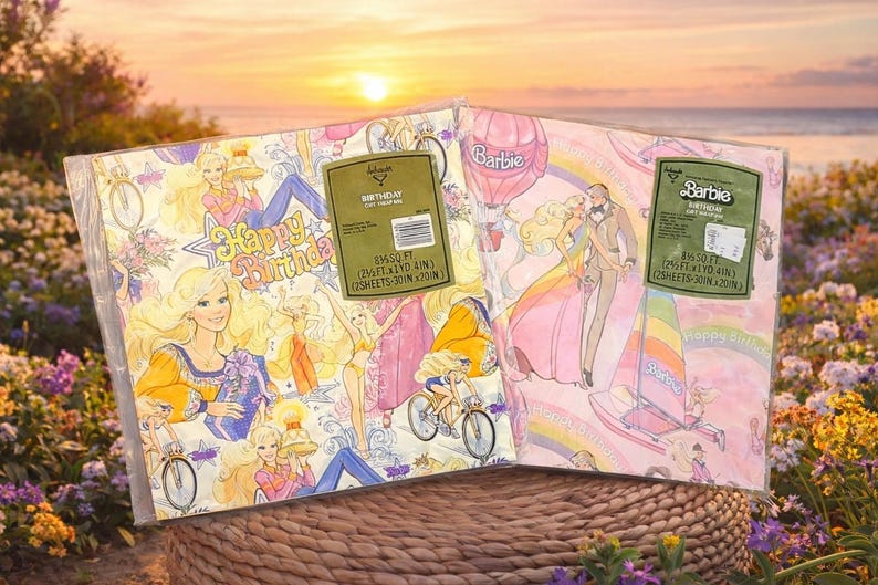 May include: Two sheets of vintage Barbie wrapping paper. One sheet has a pink background with Barbie and Ken, a rainbow, and a sailboat. The other sheet has a white background with Barbie, bicycles, and the words "Happy Birthday".