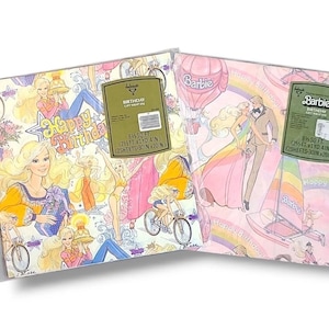 May include: Two sheets of Barbie birthday gift wrap in a plastic sleeve. The wrap features illustrations of Barbie in various outfits, along with the text "Happy Birthday." The background colors are pink and white.