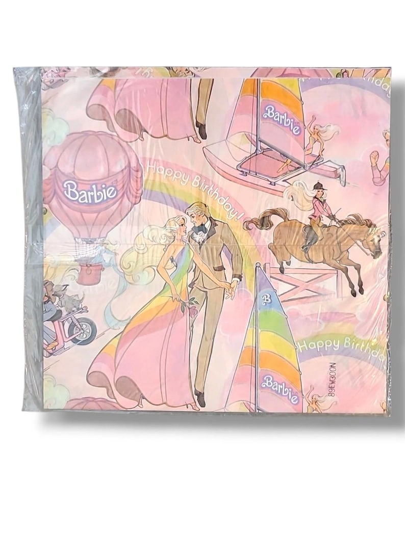 May include: A package of Barbie-themed paper napkins. The napkins feature illustrations of Barbie and Ken, sailboats, a hot air balloon, and a horse. The words "Happy Birthday!" and the Barbie logo are also visible.