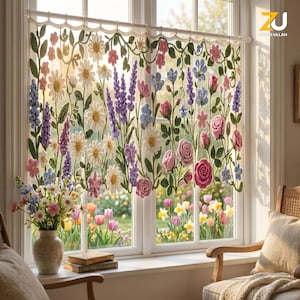 May include: A crochet window curtain featuring a floral pattern with white daisies, purple lavender, pink roses, and green vines. The curtain is suspended from a white rod with a scalloped top edge, displaying intricate needlework and textures.