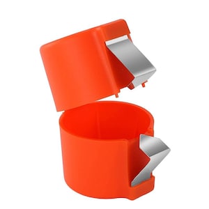 May include: An orange plastic tool with a hinged lid and two silver metal blades. The tool is open, revealing a cylindrical interior. The blades are positioned on the sides of the tool.