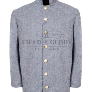 May include: A gray wool jacket with a mandarin collar and six gold-colored buttons. The jacket has long sleeves and a black collar lining. The text "FIELD OF GLORY THREADS" is printed on the front of the jacket.