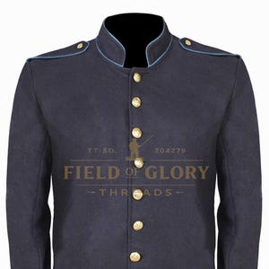 May include: A navy blue jacket with a mandarin collar and gold-coloured buttons. The jacket has light blue trim along the collar and shoulders. The text "FIELD OF GLORY - THREADS" is printed on the front.