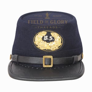 May include: A navy blue Civil War kepi hat with a black leather visor and chin strap. The hat features a gold embroidered emblem with the letters "U.S." and the text "FIELD OF GLORY - THREADS".