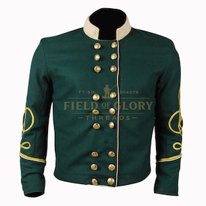 May include: A dark green military-style jacket with gold-colored buttons and trim. The jacket has a cream-colored collar and cuffs, and gold embroidery on the sleeves. The text "FIELD OF GLORY - THREADS -" is printed on the front.