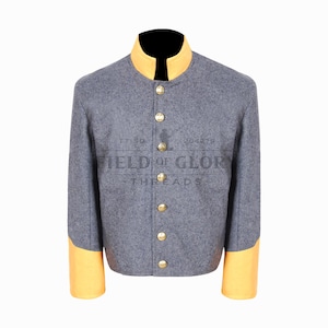 May include: A gray jacket with a yellow collar and cuffs. The jacket has gold buttons down the front and the text "FIELD OF GLORY THREADS" is printed on the front.