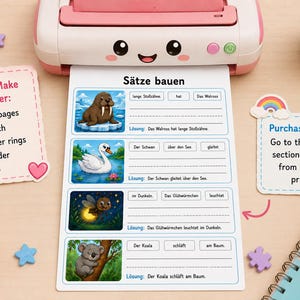 May include: A pink and white printer is printing educational worksheets with animal illustrations and German sentences. The worksheets include images of a walrus, swan, firefly, and koala. Decorative elements include a plant, pencils, and star-shaped decorations.