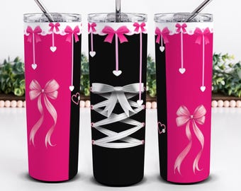 May include: Three cylindrical tumblers with lids and straws. The design features a black and hot pink color scheme with white lace trim, hanging pink bows, small white heart accents, and a central white corset-style lace-up graphic.