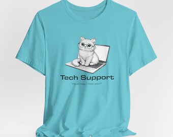 May include: A light blue t-shirt featuring a graphic of a cat wearing glasses sitting on a laptop. The text "Tech Support" and "How may I help you?" are printed below the graphic. The shirt is made of a soft material.