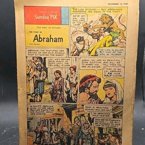 Op de afbeelding: Een vintage Sunday Pix stripverhaal van 14 november 1954 getiteld The Story of Abraham from Genesis. De pagina bevat kleurrijke illustraties van bijbelse scènes, waaronder een leeuwenaanval, reizen door de woestijn en tekstballonnen over Abraham, Sarah en de Farao.