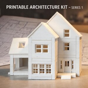 May include: A white model house with multiple windows, a front door, and a porch. The house is constructed from small, rectangular pieces, with the text "PRINTABLE ARCHITECTURE KIT - SERIES 1" at the top.