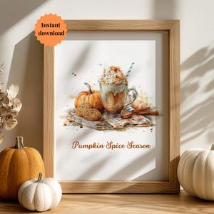 May include: Watercolor print in a wooden frame featuring a pumpkin spice latte with whipped cream, a pumpkin, cookies, and cinnamon sticks. The text "Pumpkin Spice Season" is displayed below the image. An orange sticker with the words "Instant download" is in the upper left corner.