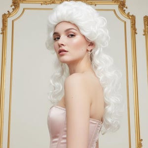 May include: A woman wearing a white wig and a light pink corset. The wig is styled in a classic, voluminous design with curls. The corset is a strapless design with a satin finish. The background features ornate gold trim.