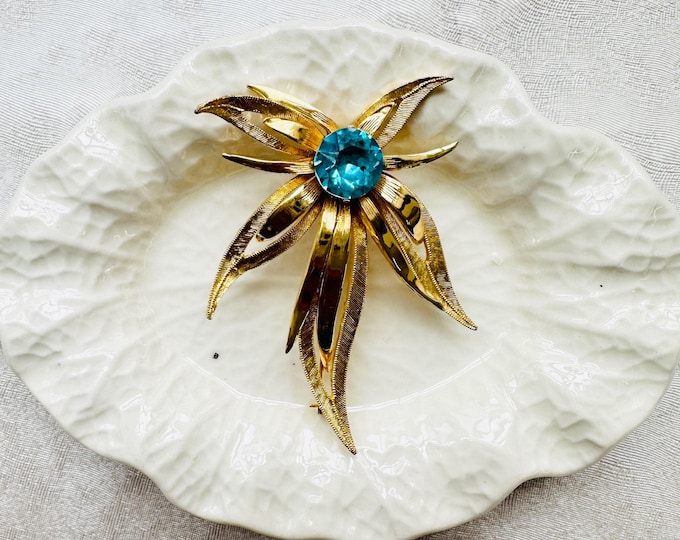 Vintage gold starburst brooch with large aqua glass stone | 1960s glam