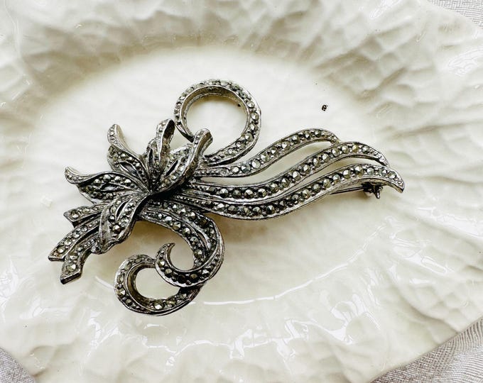 Art Deco style silver tone floral brooch with marcasite detail, 1980s