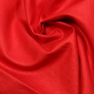 May include: Close-up of vibrant red fabric, tightly swirled to create a central spiral. The material has a subtle sheen, with visible texture and folds. The overall effect is rich and dynamic.