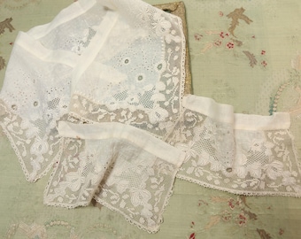 May include: A set of three white lace trims with delicate floral patterns. The trims are made of a fine, sheer fabric and have a scalloped edge.