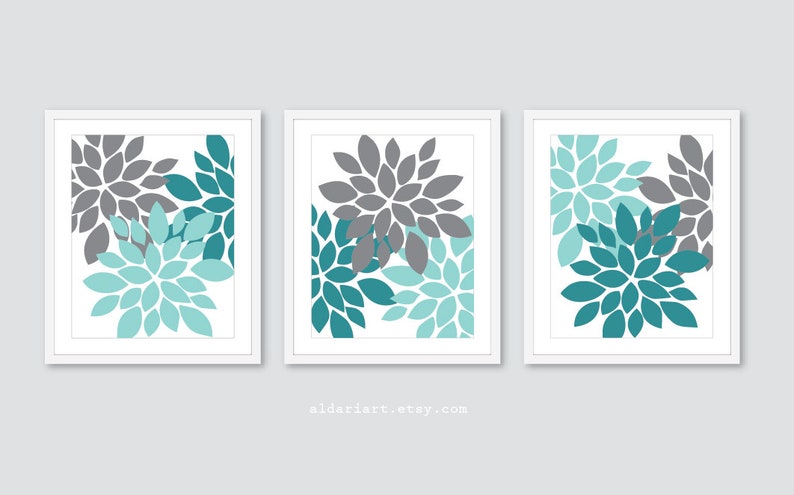 May include: Three framed floral art prints. Each print features a stylized flower design in shades of gray and teal on a white background. The artwork is framed in a white border. The Etsy shop name aldariart.etsy.com is visible.