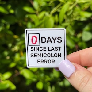 May include: White sticker with black text that reads "0 DAYS SINCE LAST SEMICOLON ERROR". The number 0 is in red.