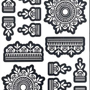 May include: Black and white henna stencil sheet with various floral and geometric designs. Includes a large circular mandala, floral borders, and smaller decorative elements. The text "AY 151" is at the top.