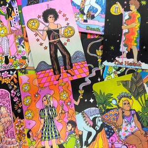 May include: A colorful set of tarot cards featuring illustrations of people in various poses. The cards are arranged in a random order, with some cards partially visible. The cards are printed on a white background with black outlines. The cards feature a variety of colors, including pink, blue, green, yellow, and orange.