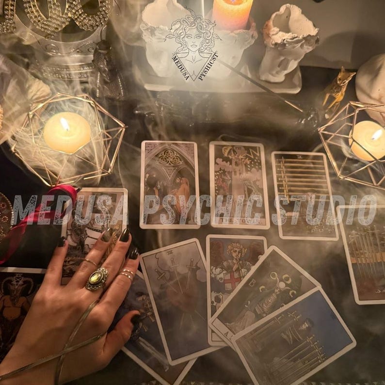 May include: A mystical scene featuring tarot cards laid out on a dark surface, with lit candles and decorative objects. The cards display detailed illustrations. The text "MEDUSA PSYCHIC STUDIO" is visible. The scene evokes a sense of divination and spirituality.