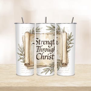 May include: A set of three white stainless steel tumblers with black straws. Each tumbler features the text "Strength Through Christ" on a parchment scroll design, surrounded by olive branches. The background has faint script.