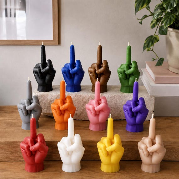 A hand-poured sculptural candle shaped like a raised middle finger — functional decor that says exactly what it needs to say.
