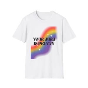 May include: White t-shirt with a rainbow graphic and the text "YOUR AURA IS PRETTY" in black.