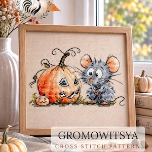 May include: A framed cross-stitch pattern featuring a gray mouse standing next to a large orange jack-o'-lantern and a small pumpkin on a beige fabric background. The text GROMOWITSYA CROSS STITCH PATTERN is printed in black and red at the bottom.