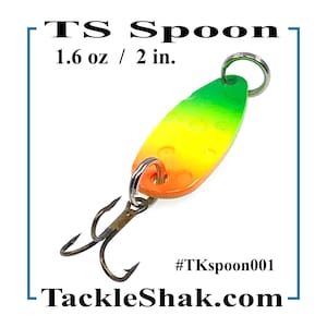 May include: A colorful fishing spoon with a green, yellow, and orange finish. The spoon is 2 inches long and weighs 1.6 ounces. It has a treble hook and a ring for attachment. The text on the image says "Trout - Bass - Pan Fish" and "TS Spoon".