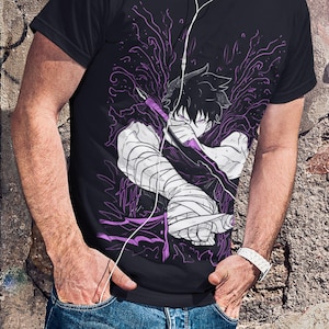May include: Black t-shirt featuring a purple and white anime-style graphic. The design depicts a character with a sword and bandages, surrounded by purple energy. The shirt is paired with blue jeans.