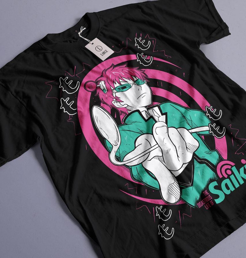 May include: Black t-shirt featuring a graphic of an anime character with pink hair, green glasses, and a green jacket holding a spoon. The design includes pink and white accents and the word "Saiki".