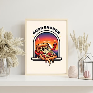 May include: A framed print with a cartoon pizza slice character. The pizza has a smiling face, pepperoni, and other toppings. The words "GOOD ENOUGH" are above the pizza, set against a sunset backdrop.