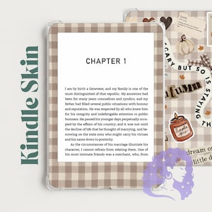 May include: A Kindle skin featuring a beige and white gingham pattern. The design includes decorative elements like a pumpkin, a candle labelled Pumpkin Spice, a bow, and text that reads Scary but so is staying the same and Autumn.